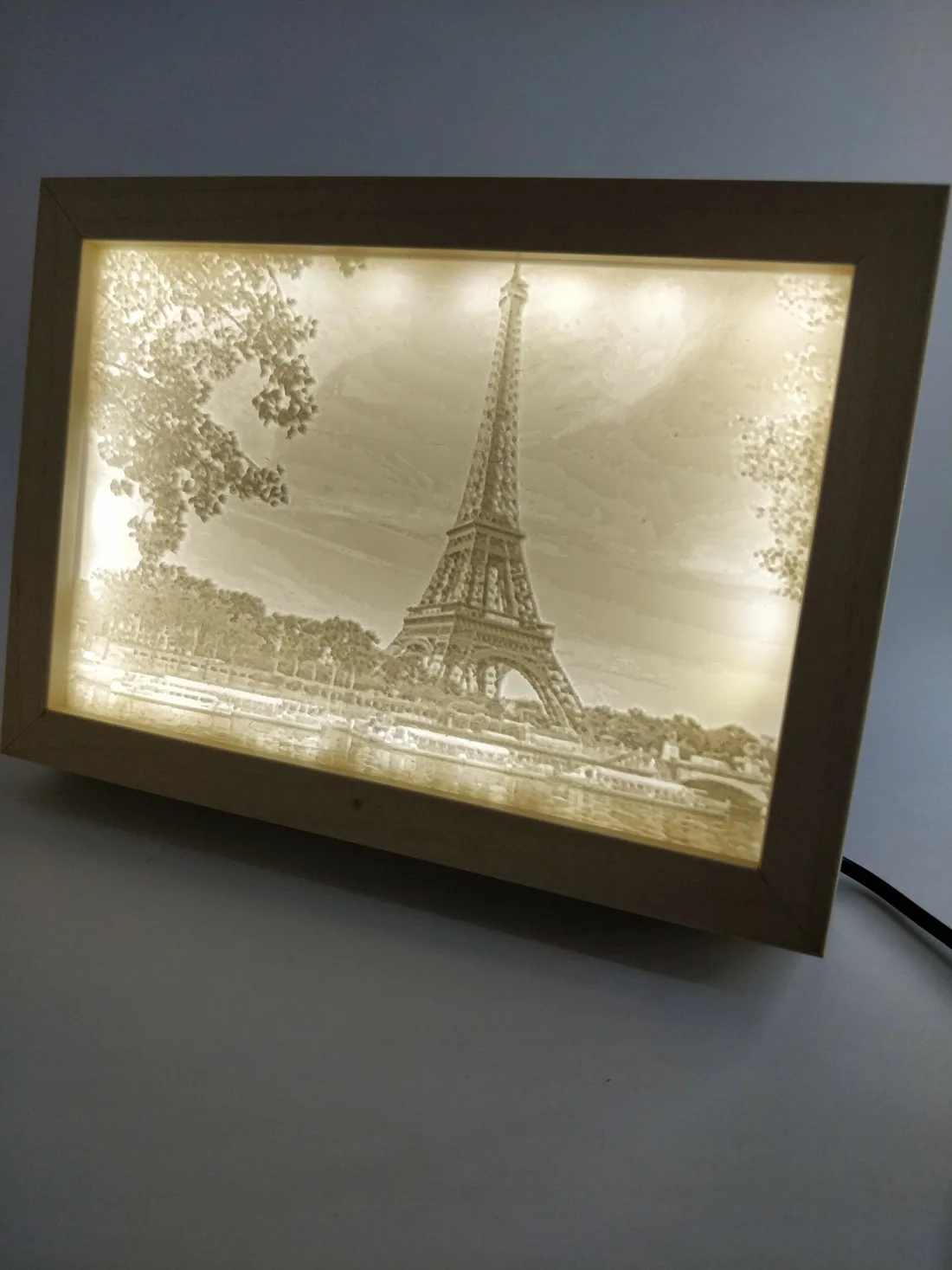 Lithophanie de la tour Eiffel, allumée sur un bureau